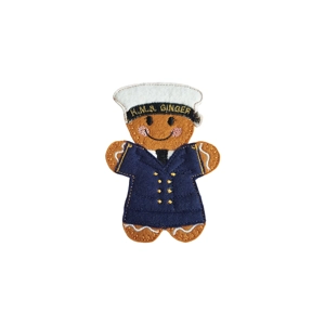A felt gingerbread WREN sailor character wearing a navy uniform and white sailor cap, with embroidered buttons, rosy cheeks, and a smiling face.