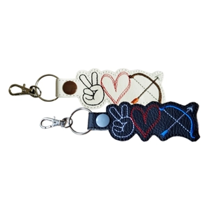 Two faux leather Peace Love Archery keyrings featuring a stitched peace sign hand, heart and bow with arrow, shown in black and white colour options.
