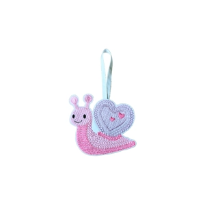 A felt snail decoration with a knit stitch–style embroidered design, carrying a heart-shaped shell, with a hanging loop.
