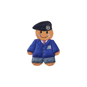 A felt gingerbread veteran character wearing a navy blue military-style blazer with stitched medal details, a matching beret, tie, and trousers, with a gentle stitched smile.