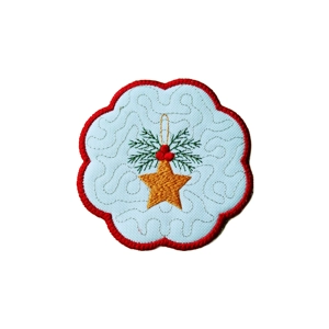 Embroidered Christmas candle coaster with a golden star, red berries and green foliage on a white scalloped mat with a red stitched border.