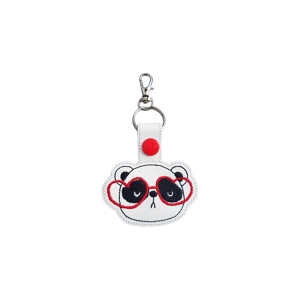 A faux leather panda keyring with an embroidered panda face wearing red heart-shaped glasses, finished with a silver keyring clip.