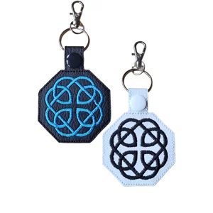 Black and white Celtic fatherhood knot keyrings with embroidered knot designs and silver metal hardware.