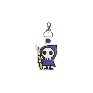 Faux leather keyring embroidered with a cute grim reaper character wearing a hooded cape and holding a seam ripper, known as the Stitch Reaper.