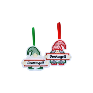 Whimsical Gnome Greetings Christmas Ornament made from soft felt, featuring two embroidered gnomes holding ‘Greetings!!!’ signs — one with a red hat and one with a green hat, each hanging from a coloured ribbon.