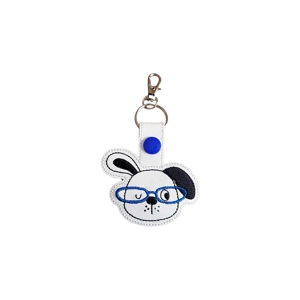 An embroidered puppy keyring with a winking puppy face wearing blue glasses, finished with a silver keyring and lobster clasp.