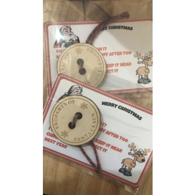 ready for resale 100 Santa buttons in packets with backing card and cord £35 per box