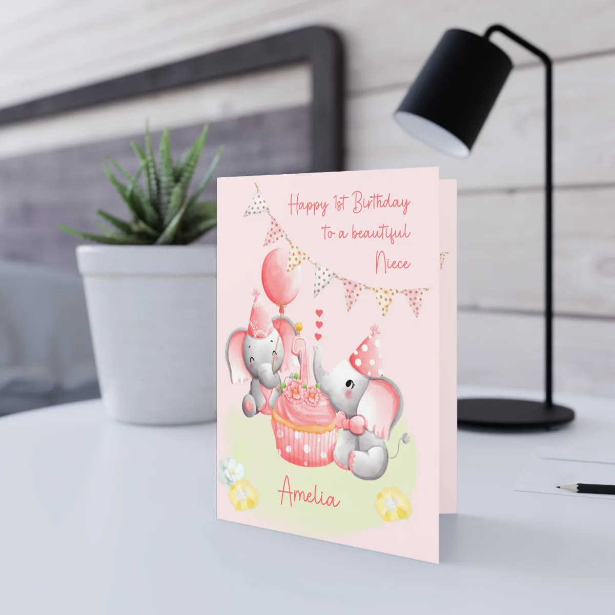 2 baby elephants having a tea party, cupcake with number 1 candle, name printed at bottom, pink background