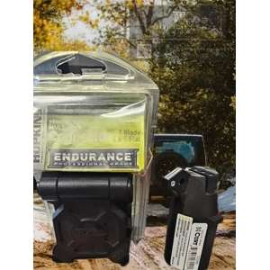 Hopkins Towing Solutions 48470 Endurance Multi-Tow Connector with Curt adapter 57240 with More4less watermark in the background. There is also a jeep on a dirt road.