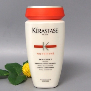 Kérastase Nutritive Bain Satin 2 Shampoo [8.5 fl. oz.] with a yellow flower next to it