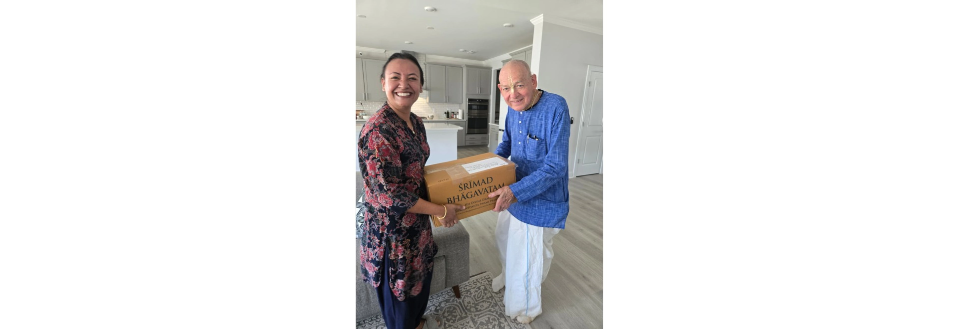 Apurva Darling, husband of Kamalini Darling, presenting a set of Srimad Bhagavatam