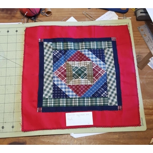 square quilt on green, red, or dark blue