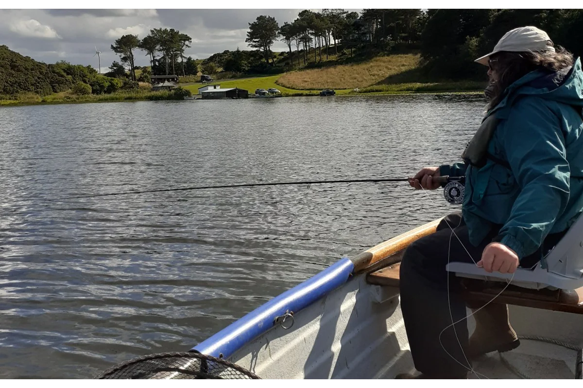 Fly fishing from a boat on a Scottish loch