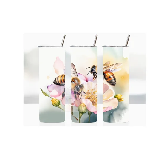 Introducing 'Nectar Bloom' our exquisite 20oz Skinny Tumbler, a perfect blend of functionality and artistic beauty. This stunning tumbler features a captivating image of two bees gracefully perched on a vibrant flower, set against a mesmerizing watercolour background
