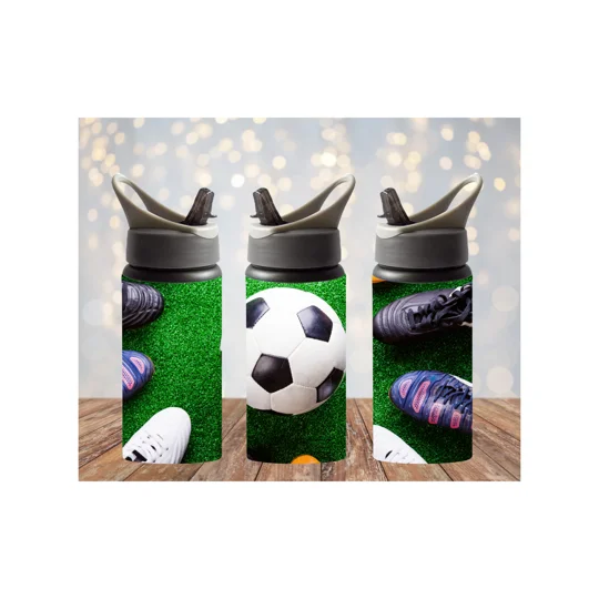 A soccer ball sits on bright green artificial turf, surrounded in a circle by several pairs of soccer cleats. The ball has the words “Team Tommy” printed on it, creating a sense of team spirit and unity.