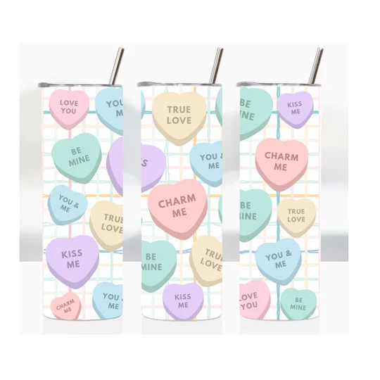 Pastel-colored candy hearts arranged on a light checkered background, each printed with short romantic messages like “Love You,” “You & Me,” “True Love,” “Be Mine,” “Kiss Me,” and “Charm Me.”