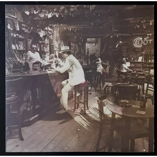 Led Zeppelin – In Through The Out Door (Alternative Cover Edition) is one of the band’s most creatively packaged albums and a true collector’s piece. Originally released in 1979, this version includes a brown paper bag outer sleeve with the band name and title stamped on the front, designed to resemble a bootleg.