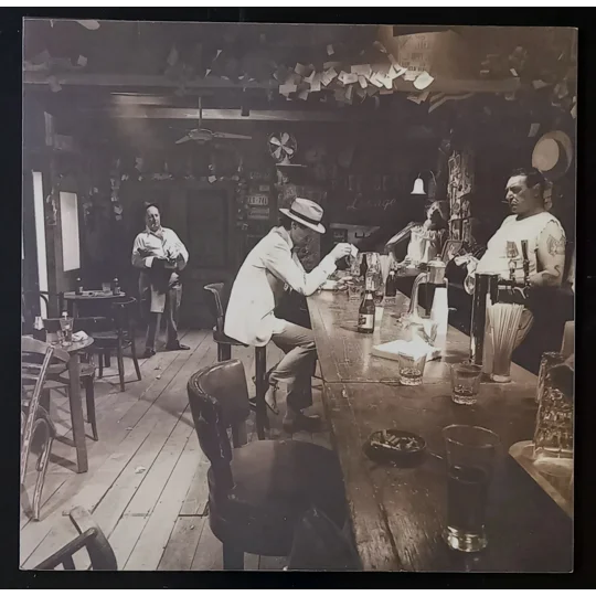 Led Zeppelin – In Through The Out Door (Alternative Cover Edition) is one of the band’s most creatively packaged albums and a true collector’s piece. Originally released in 1979, this version includes a brown paper bag outer sleeve with the band name and title stamped on the front, designed to resemble a bootleg.