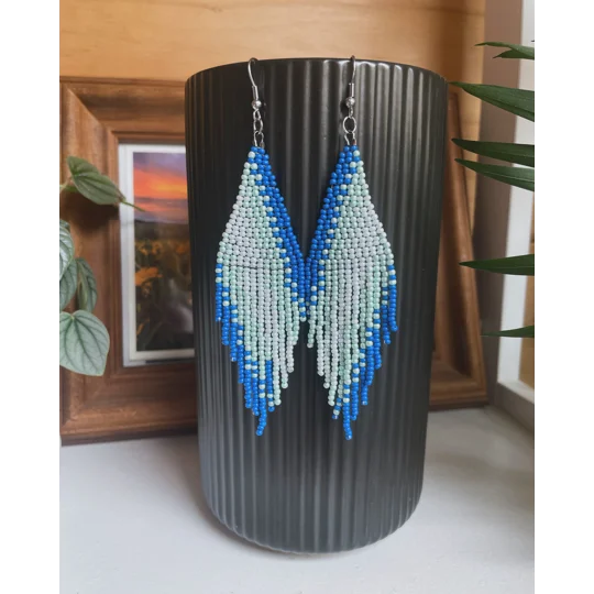 A pair of handmade beaded fringe earrings. Colors in a gradient Blue, Light Blue, Sparkle Blue