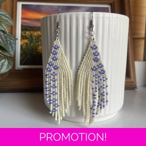 A pair of handmade beading earrings. in White with purple forget-me-not flowers