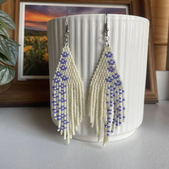 A pair of handmade beading earrings. in White with purple forget-me-not flowers