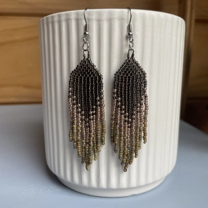 Handmade beaded Earrings,

Where colours cascade in a breathtaking display of vibrancy and elegance. Each bead is carefully selected to create a mesmerising gradient effect, reminiscent of a cascading waterfall of hues. 
Earthy Tones