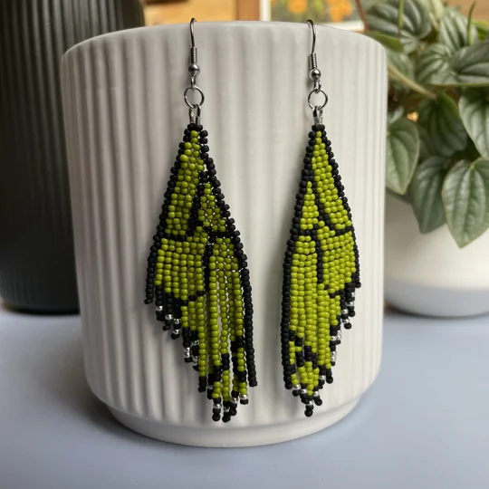 Unique earrings feature intricate beadwork, capturing the delicate charm of butterfly wings in vibrant green