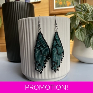 Unique earrings feature intricate beadwork, capturing the delicate charm of butterfly wings in vibrant frosted blue that glows in the sunlight