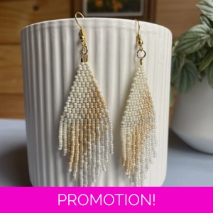 A pair of handmade beaded fringe earrings. Colors in a gradient antique whites