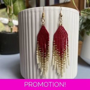 Handmade beaded Earrings

Where colours cascade in a breathtaking display of vibrancy and elegance. Each bead is carefully selected to create a mesmerising gradient effect, reminiscent of a cascading waterfall of hues. 
Red, Gold, and white