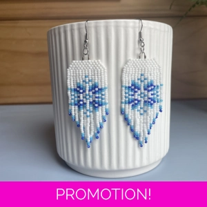 handcrafted Christmas earrings in classic  white and hues of blue.  Snowflake design