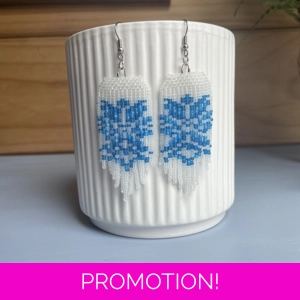 Add festive cheer to your style with our handcrafted Christmas earrings in classic frosted white and hues of blue.