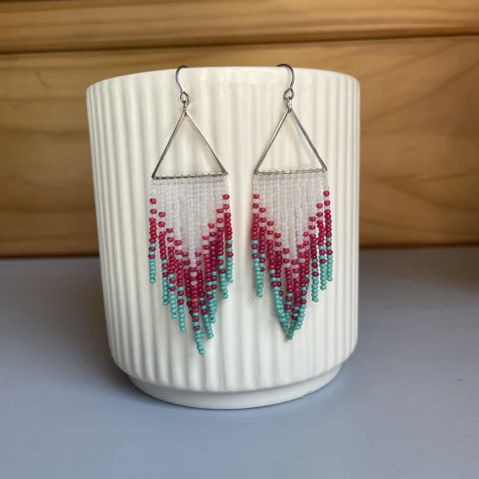 These distinctive earrings seamlessly blend geometric precision with a touch of cool sophistication. The silver triangles add a contemporary edge, while the colored beads infuse a subtle pop of color, creating a unique and eye-catching accessory.

frosted white, magenta, aqua