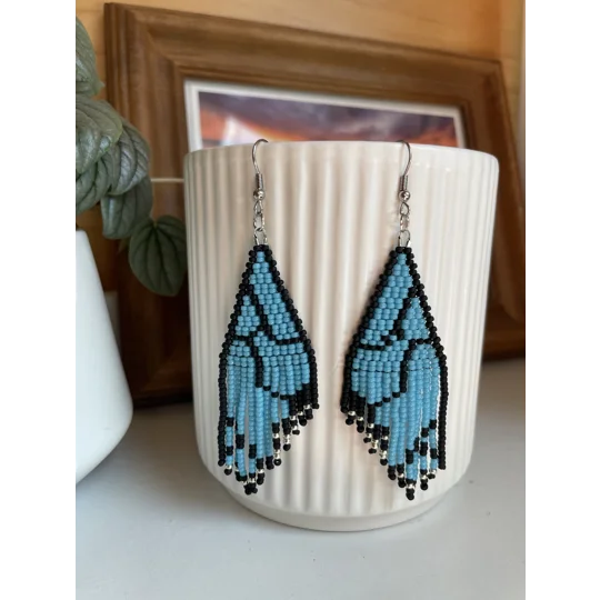 Unique earrings feature intricate beadwork, capturing the delicate charm of butterfly wings in vibrant blue