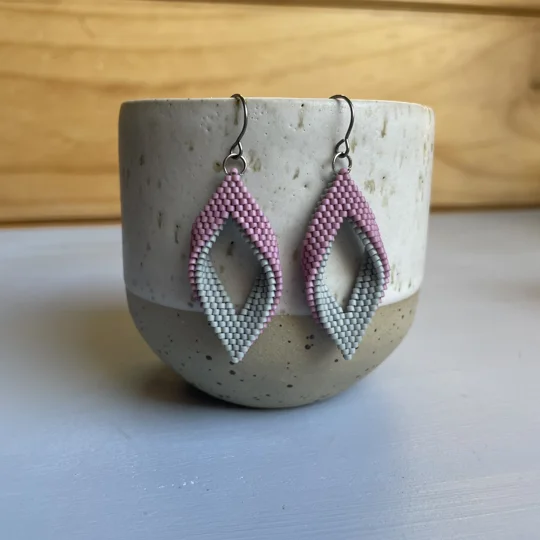 matte gray and matte pink
 handwoven earrings feature a unique twisted marquise shape, combining clean lines with a gentle three-dimensional curve. Their open design adds a sense of lightness and movement, making them a subtle statement piece for any outfit. Crafted with precision using high-quality Miyuki Delica beads, they’re lightweight, comfortable to wear, and perfect for everyday style or special occasions.