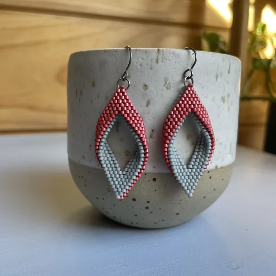 grey and cranberry
 handwoven earrings feature a unique twisted marquise shape, combining clean lines with a gentle three-dimensional curve. Their open design adds a sense of lightness and movement, making them a subtle statement piece for any outfit. Crafted with precision using high-quality Miyuki Delica beads, they’re lightweight, comfortable to wear, and perfect for everyday style or special occasions.
