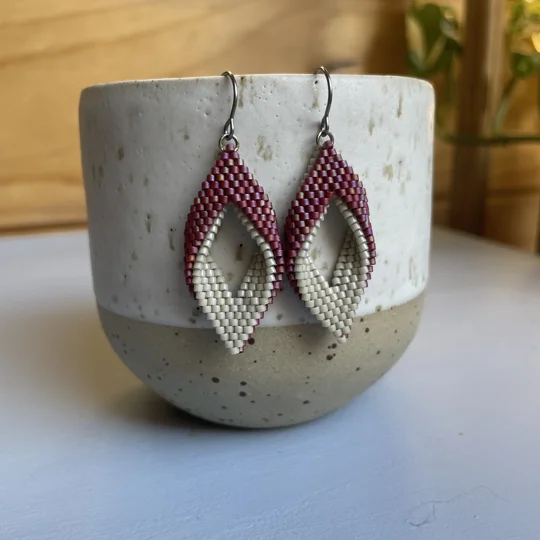 handwoven earrings feature a unique twisted marquise shape, combining clean lines with a gentle three-dimensional curve. Their open design adds a sense of lightness and movement, making them a subtle statement piece for any outfit. Crafted with precision using high-quality Miyuki Delica beads, they’re lightweight, comfortable to wear, and perfect for everyday style or special occasions.