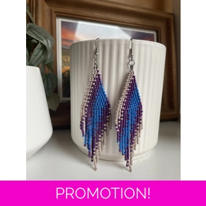 A pair of handmade beaded fringe earrings. Colors in a gradient Beige, Purple, and blue