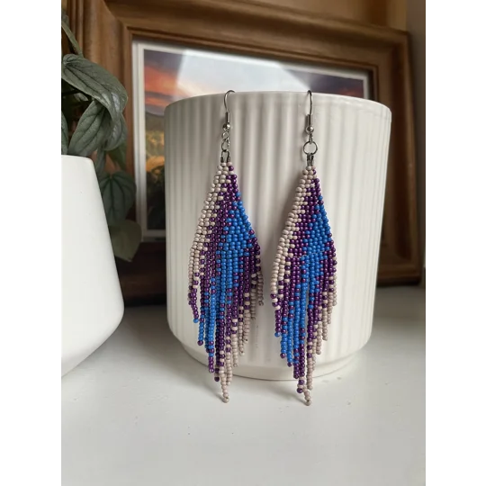 A pair of handmade beaded fringe earrings. Colors in a gradient Beige, Purple, and blue