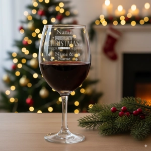Gift Boxed Engraved Wine Glass with Merry Christmas From with red wine in glass and festive background