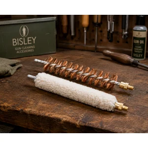 Bisley long wool mop and phosphor bronze gun cleaning brush displayed on a traditional workshop bench in The Country Sports Store Workshop Collection, ideal for shotgun and rifle barrel cleaning and maintenance.