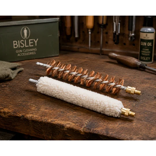 Bisley long wool mop and phosphor bronze gun cleaning brush displayed on a traditional workshop bench in The Country Sports Store Workshop Collection, ideal for shotgun and rifle barrel cleaning and maintenance.