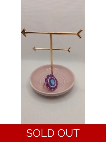 Hand sewn ring with blue gem stone