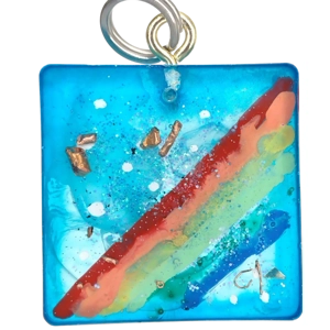 Handmade pendant rainbow against a blue sky