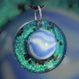 Cosmic pendant with EMF protection representing Earth.