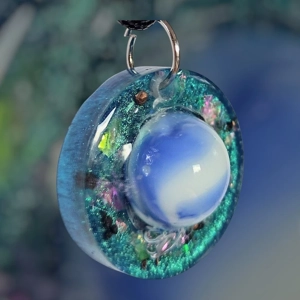 Cosmic pendant with EMF protection representing Earth.