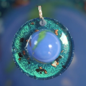 Cosmic pendant with EMF protection representing Earth.