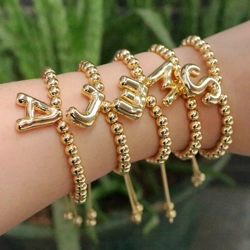 Beaded bracelet with bubble letter charm