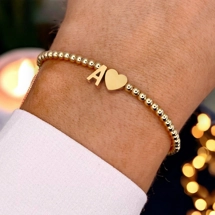 Beaded bracelet with heart and letter pendants